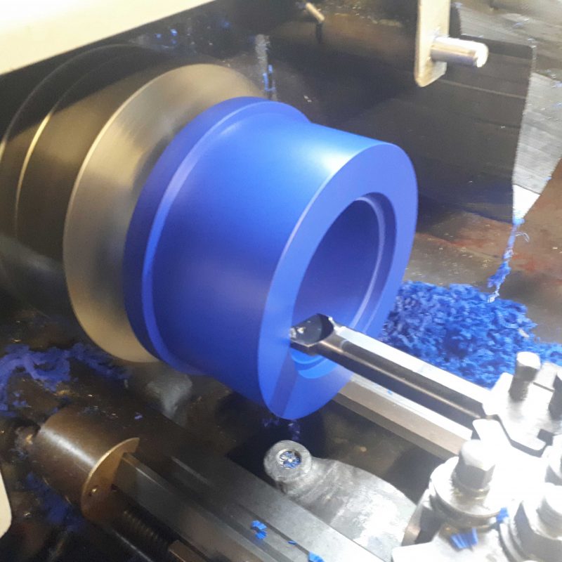 BLUE-ACETAL-BUSH-MANUAL-MACHINING.-custom-machined--acetal-bush-to-fit-scheduel-pipe